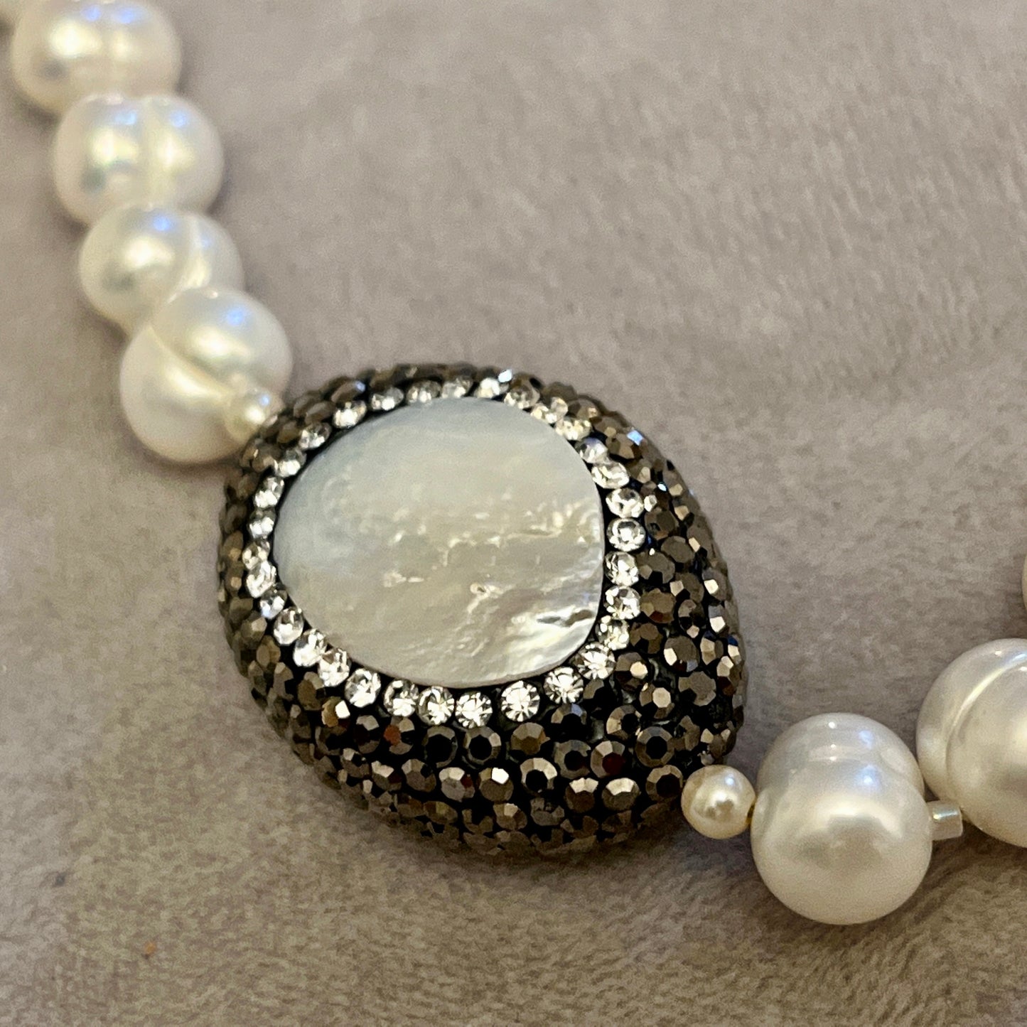 Pearl  with elements in  Mother of Pearl surrounded by crystals