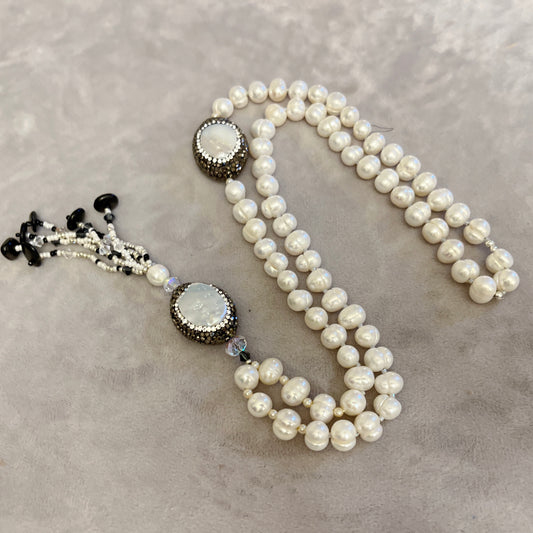 Pearl  with elements in  Mother of Pearl surrounded by crystals